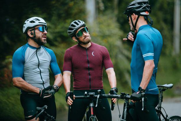 three male cyclists talking tips cycling