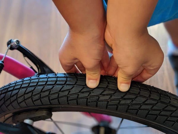 kid check tire pressue holding bike safety tips kids