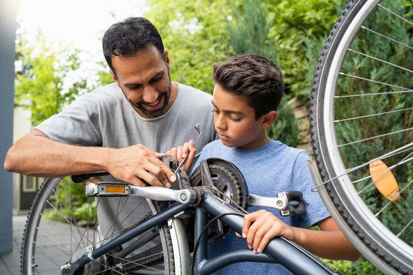 father and son fixing bike daytime tips for kids