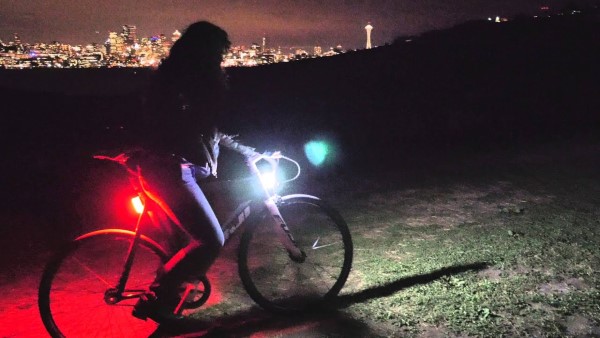 person riding bike with lights on night time safety tips children