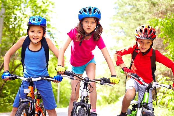 kids riding bike daytime happy safety