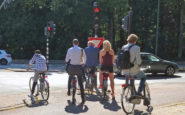 people standing with bike waiting for traffic obey traffic rules safe cycling tips adults 2023