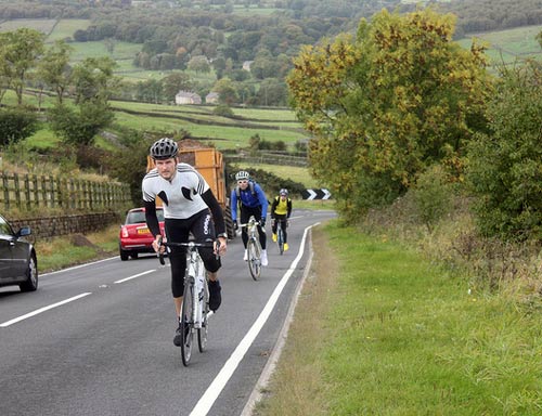 group of cyclists riding bike ride defensively tips for adults 2023