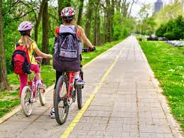 woman and child biking sidewalk safety tips 2023
